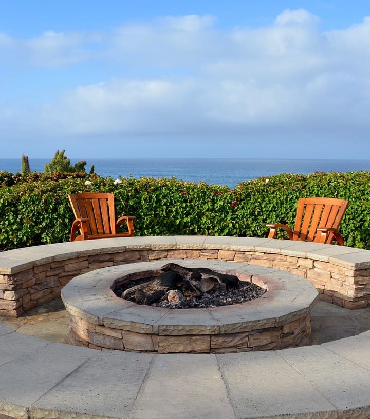 A fire pit with chairs around it